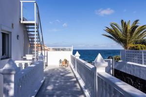 a stairway leading down to a beach with the ocean at A Luxurious Villa On The Island Of Tenerife in Playa de San Juan