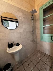 a bathroom with a sink and a mirror at Petra Hotel & Coffee House in Urfa