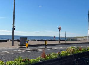 an empty street with the ocean in the background at Grand Hotel Sunderland in Sunderland