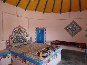 a bedroom with a bed in a tent at Whiterann village Homestay in Dhordo