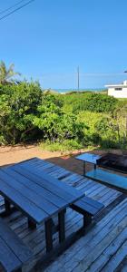 two picnic tables sitting on top of a wooden deck at Klein Jongens in Jongensfontein