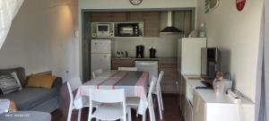 a small kitchen with a table and a couch at appartement T1bis St Lary soulan village in Saint-Lary-Soulan