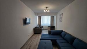 un soggiorno con divano blu e TV di Nordic Residence 28 a Suceava