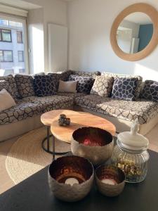 a living room with a couch and a table at Sunny Home in Knokke-Heist