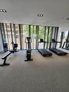 a gym with treadmills and ellipticals in a room with windows at Lennox Z in Accra