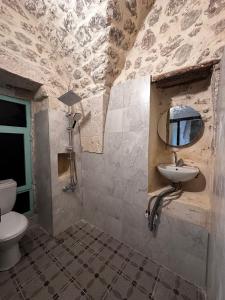 a bathroom with a sink and a toilet at Petra Hotel & Coffee House in Urfa