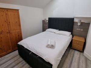 a bedroom with a bed with a pair of slippers on it at Entire Flat with Three Bedrooms N 2 in Great Yarmouth