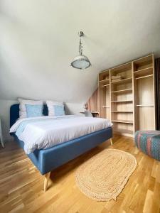 1 dormitorio con cama azul y alfombra en Gemütliches Privatzimmer im Haus, Hasenfelder Weg 15 in Heinersdorf, en Steinhöfel