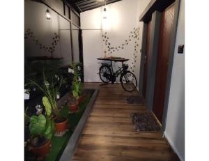 a bike parked in a room with plants at Birdwing Cottage, Munnar in Munnar