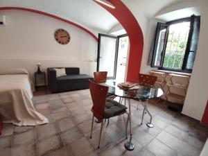 a room with a bed and a table and a couch at Ninsòle in La Morra