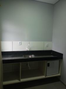 a bathroom counter with a sink in a room at HOTEL VIZON II in Vilhena