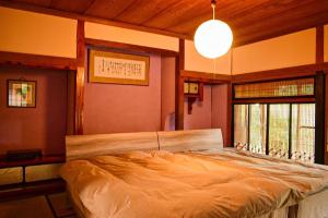a bedroom with a large bed in a room at くらやしき〜kurayashiki~ in Kami-ikusaka