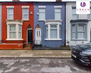 a car parked in front of a row of houses at 4 Bedroom House, Perfect For Business , Relocation, Contractors, Families By Urban Luxury Stays Short Lets & Serviced Accommodation Liverpool & Free Parking in Liverpool
