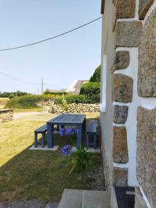 a blue picnic table sitting next to a building at Gîte breton au bord du GR34 in Landunvez +23 photos