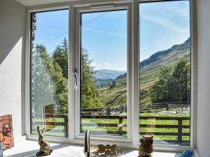 a window with a view of the mountains at Striding Edge Cottage in Glenridding