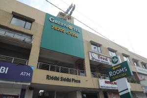 a building with signs on the side of it at Greenotel Rooms Hazira, Surat in Surat