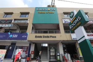a building with a sign on the front of it at Greenotel Rooms Hazira, Surat in Surat