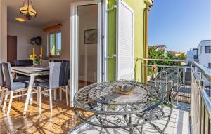 a patio with a table and chairs on a balcony at Amazing Apartment In Medulin With 3 Bedrooms And Wifi in Medulin