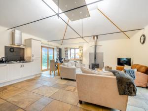 a living room with couches and a kitchen at South Steading in Seamill