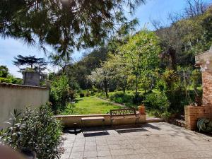 a patio with a bench in a garden at Chambre d'hôtes Bed and Breakfast in Moissac