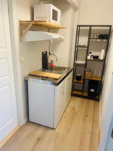 a small kitchen with a counter and a microwave at Appartment close to the city, ocean and mountains -Tromsø in Tromsø