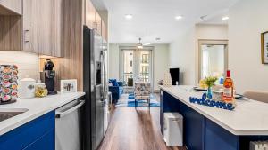 a kitchen with blue cabinets and a counter top at Cozy Retreat-Free Reserved Parking-Pool in Addison
