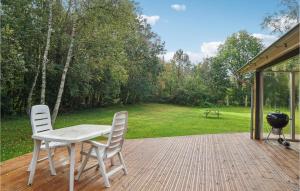 two chairs and a table on a deck with a grill at 3 Bedroom Lovely Home In Thyholm in Thyholm