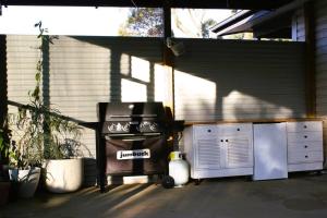 a grill sitting in a garage next to a building at Gum Lodge, Gateway to the Murray in Loxton