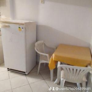 a small kitchen with a table and a refrigerator at المنظر الجميل in El Ksiba