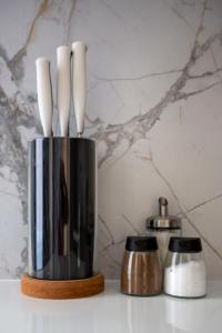 two utensils in a metal container on a counter at Luxurious Prestige Residence next to the New York Café in Budapest
