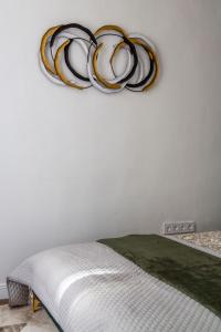 a bedroom with a bed and a chandelier on the wall at Luxurious Prestige Residence next to the New York Café in Budapest