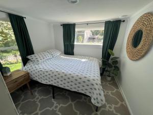 a small bedroom with a bed and a window at Sugar Sweet Home in Asheville