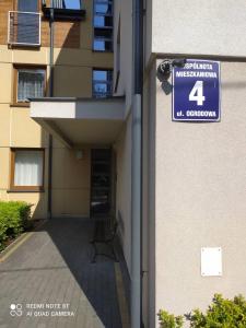 a building with a sign on the side of it at Apartament Parkowy 24h in Łomża +1 photo