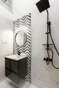 a bathroom with a sink and a mirror at Luxurious Prestige Residence next to the New York Café in Budapest