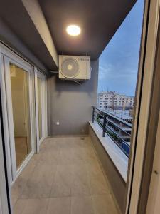 a balcony with a fan on the wall and a window at Brand new apartment in Downtown Gevgelija in Gevgelija