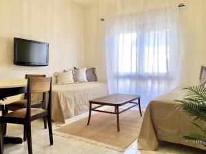 Zimmer mit einem Bett, einem Schreibtisch und einem TV in der Unterkunft Nice apartment in Santa Cruz with balcony in Santa Cruz
