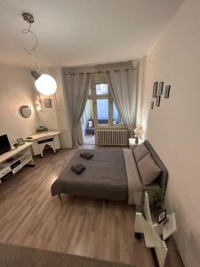 a large bedroom with a bed and a large window at Central Park Apartment in Novi Sad