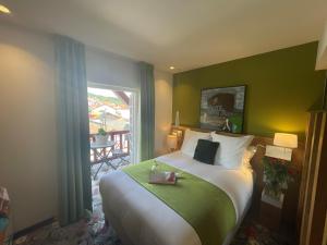 a bedroom with a bed and a window with a table at Hotel Berria in Hasparren