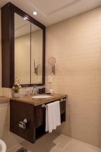 a bathroom with a sink and a mirror at INA HOMES - 2BHK Residences Tower 1 in Dubai +14 photos