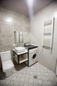 a bathroom with a washing machine and a sink at Apartment Kutaisi 248 in Kutaisi