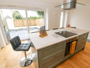 a kitchen with a counter and a sink and a stove at James' Place in Falmouth