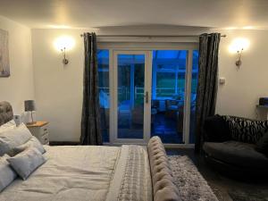 a bedroom with a bed and a sliding glass door at Country View Lodge in Bratton