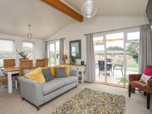 a living room with a couch and a table at 32 Sanctuary Lodge in Pwllheli