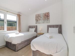 a bedroom with two beds and a window at Lodge 15 - The Tummel Family in Perth