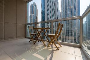 a balcony with two chairs and a table on a balcony at INA HOMES - 2BHK Residences Tower 1 in Dubai