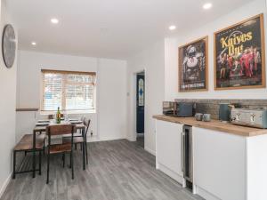 a kitchen and dining room with a table and chairs at Seabar in Burnham on Sea