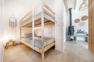 a bedroom with two bunk beds in a room at Azenhas do Mar Cliffs House in Sintra