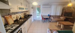 a kitchen with a table and a couch in a room at Triblex Villa I Private Beach I Walking Distance to the Sea 300 meters in Side