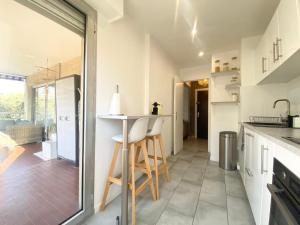a kitchen with a counter and a table in it at Apartment Antibes city-center & port in Antibes