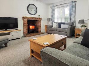 a living room with a couch and a fireplace at Askham House in York